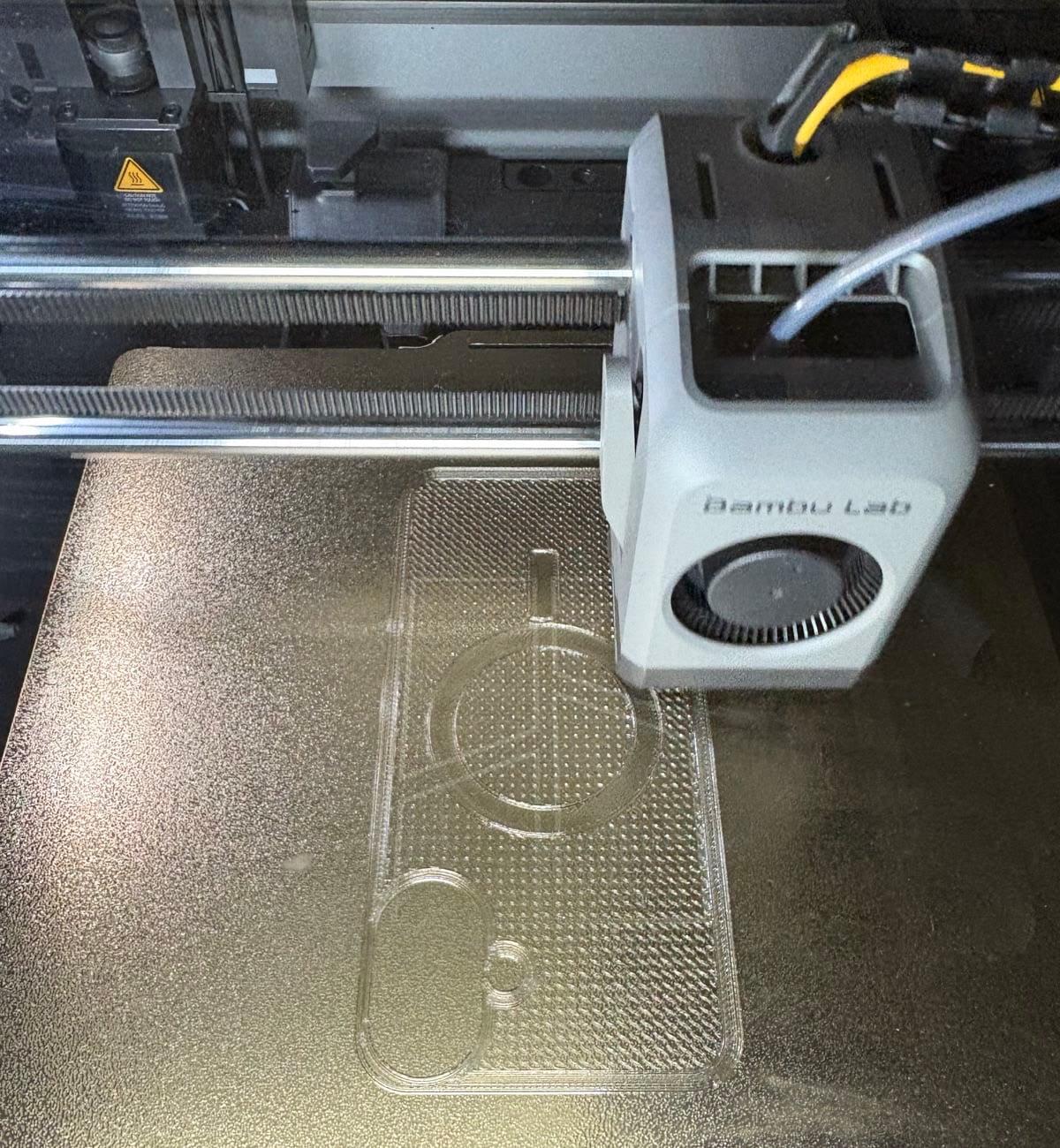 A clear 3D-printed phone case with a MagSafe ring cut-out