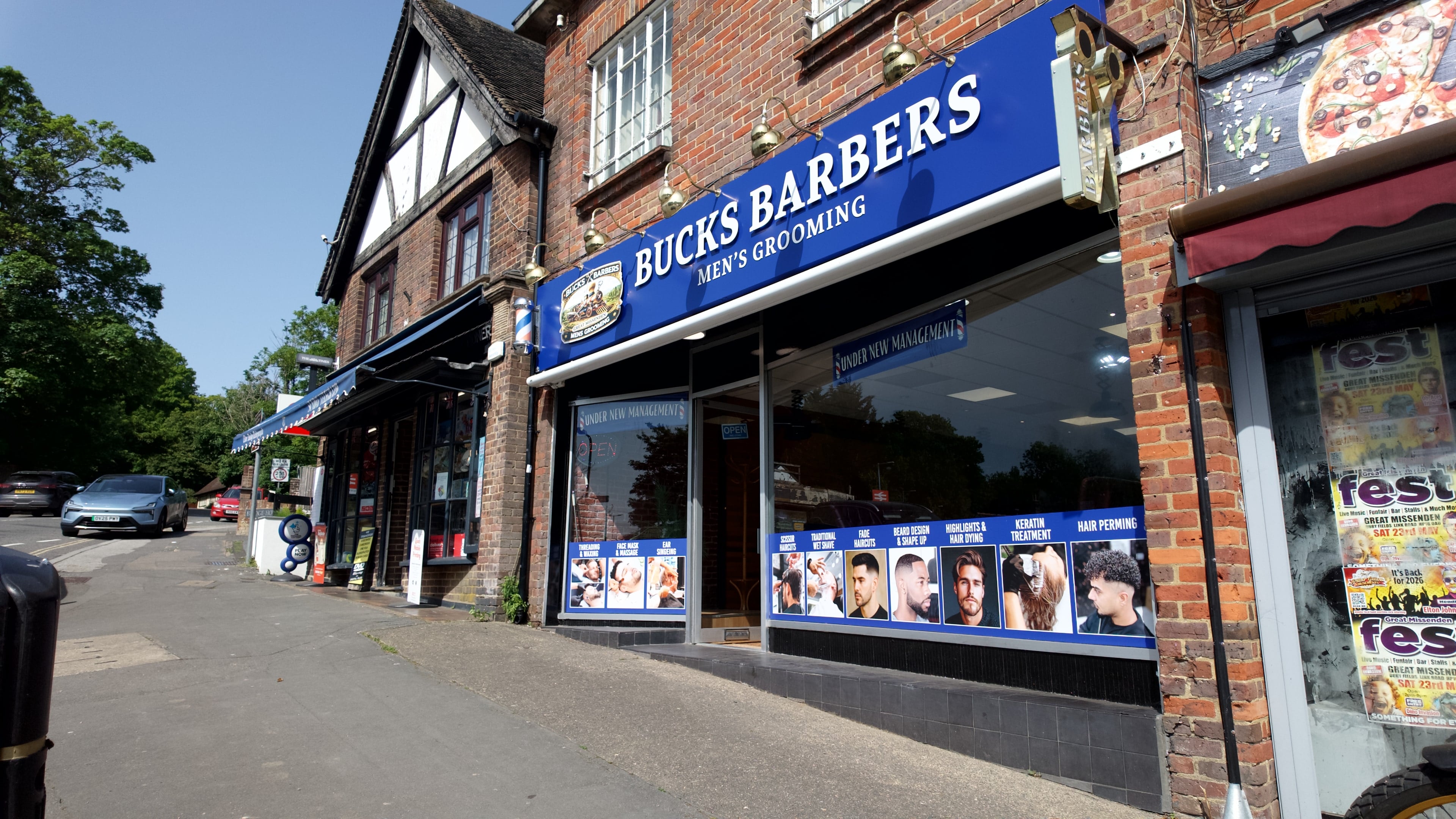 The Bucks Barbers sign down the shopping parade